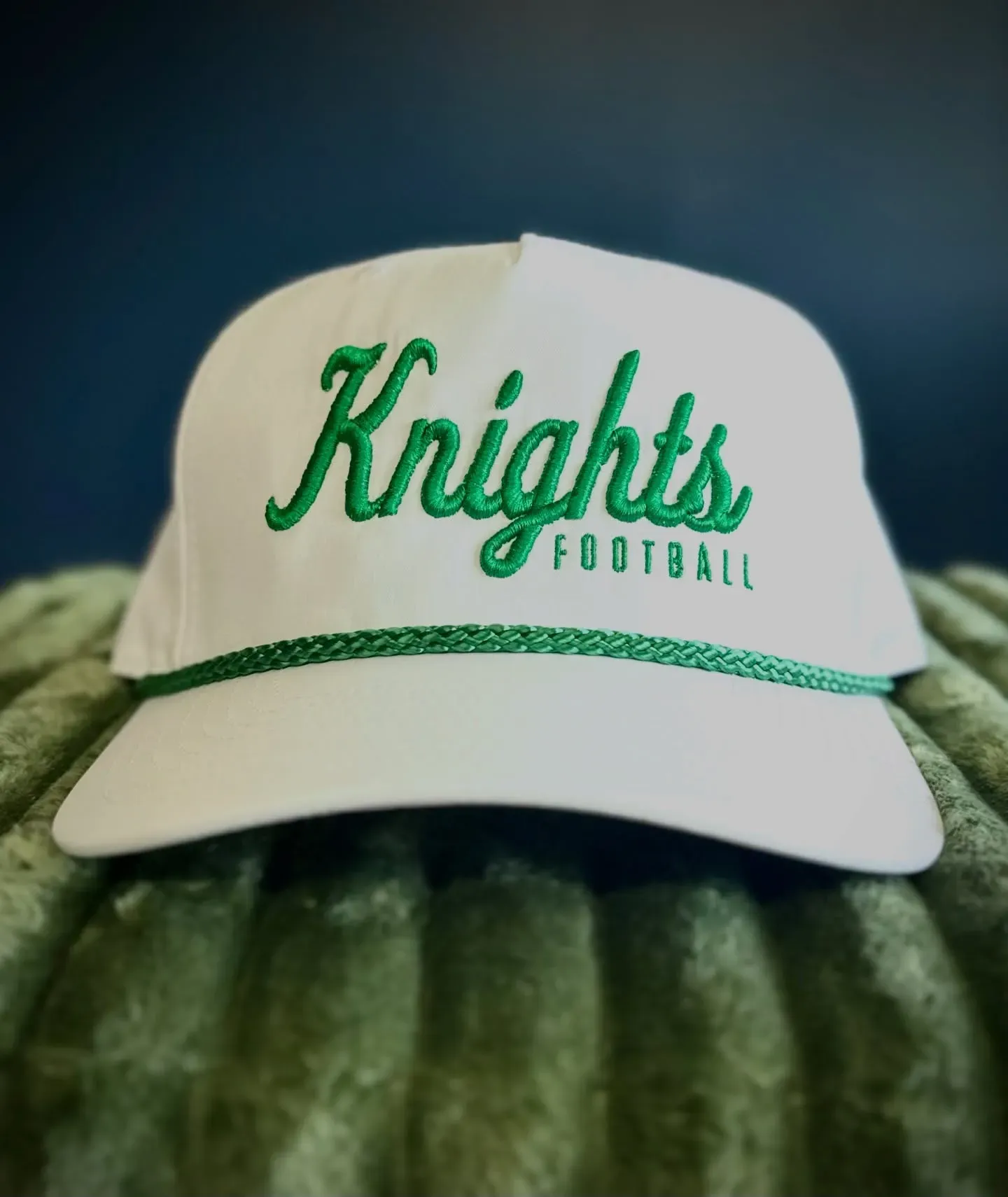Knights Football team logo featuring green 3D puff script and flat embroidery digitized for a white rope hat by Sassy Digitizing.
