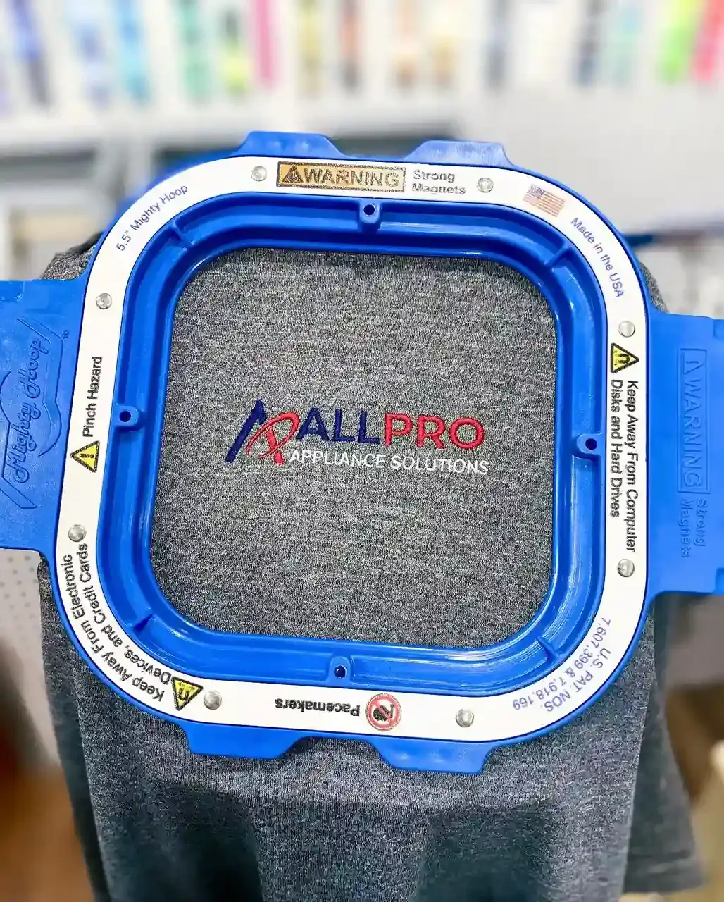 All Pro Appliance Solutions corporate logo digitized for left chest embroidery on a heather grey shirt using a magnetic Mighty Hoop.